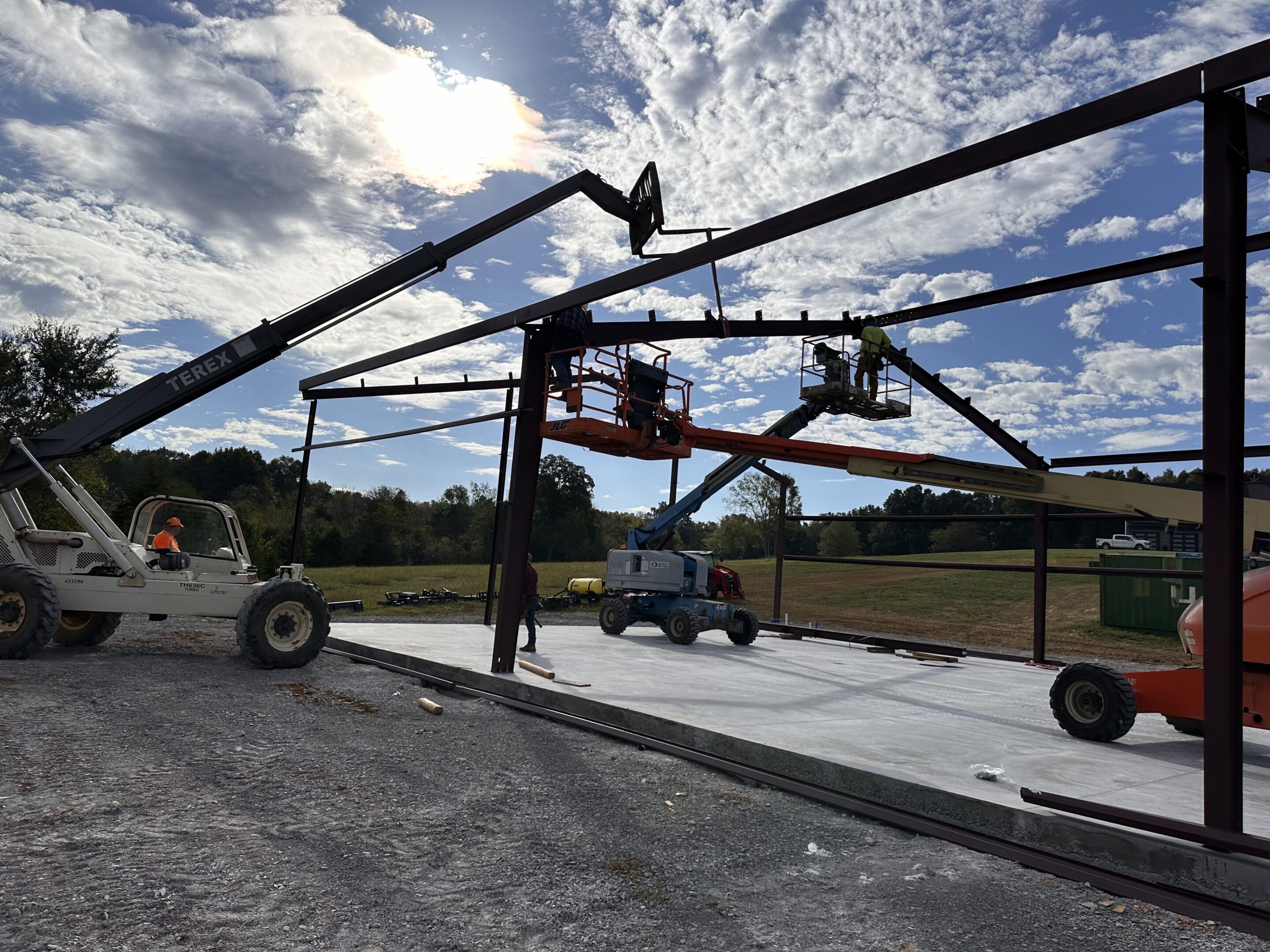 A large crane is being used to lift a tractor.
