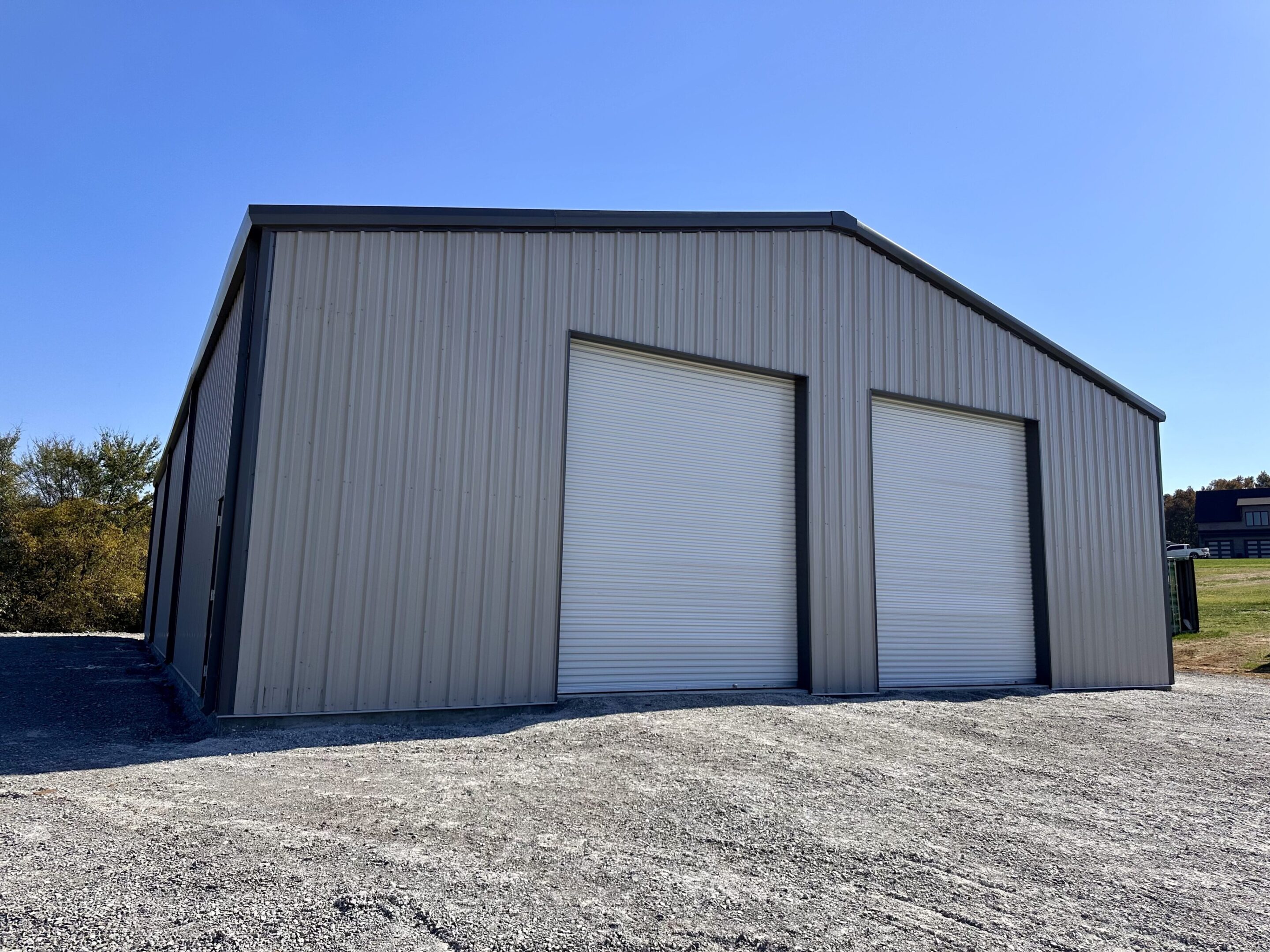 A large building with two doors on the side of it.