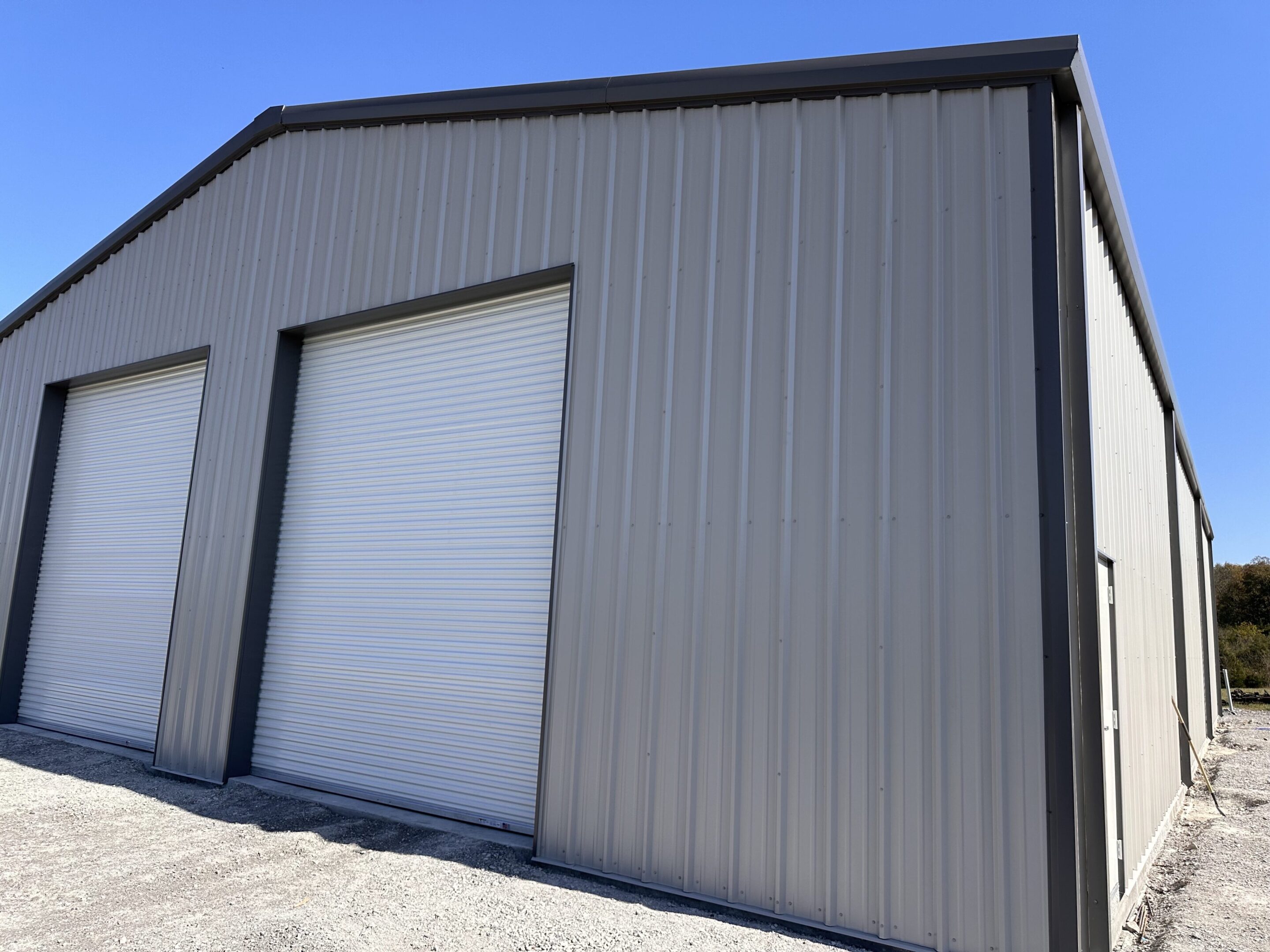A large building with two doors and a sky background