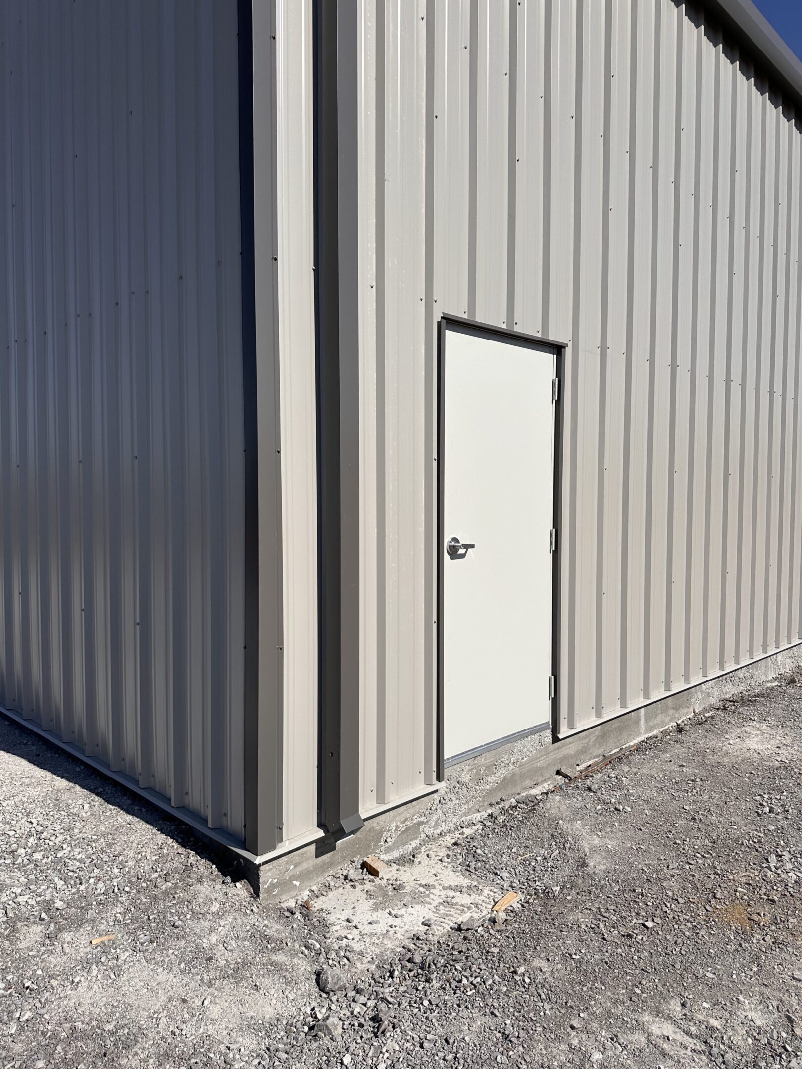 A door that is open on the side of a building.