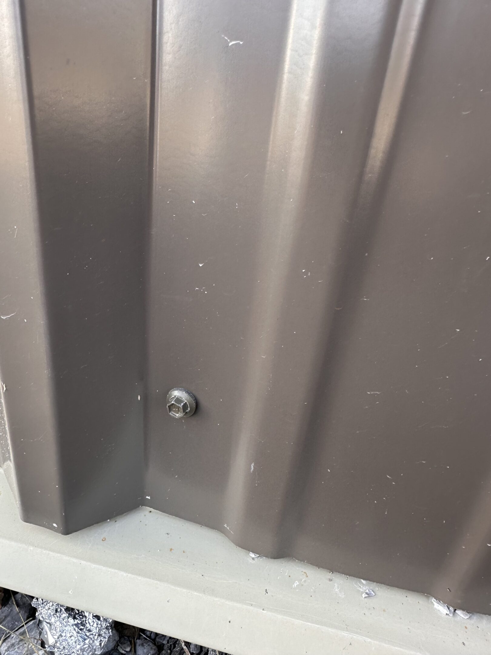A corner of a bathroom with the door open.