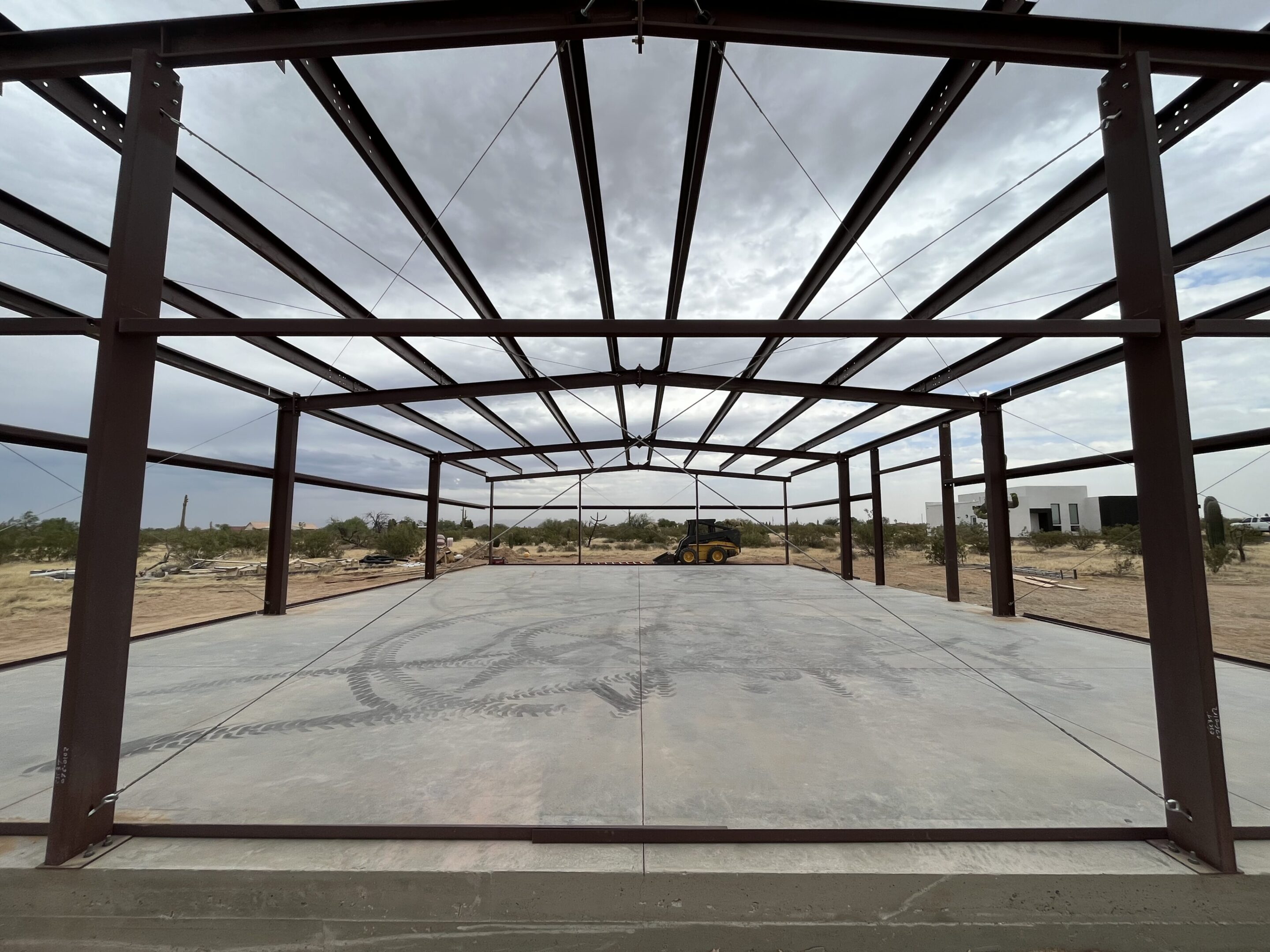 A large metal structure with no roof on the ground.