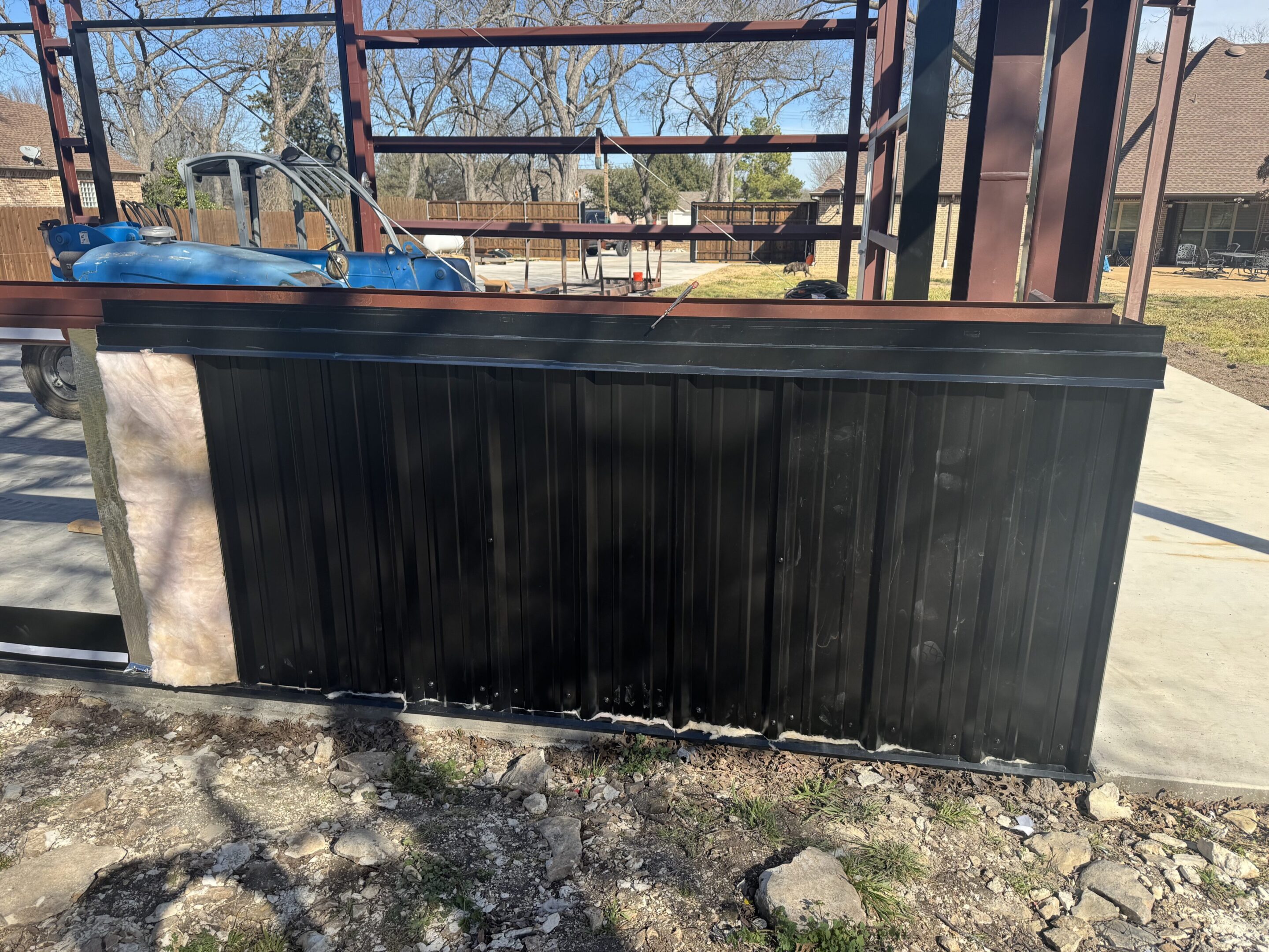 A fence that is sitting in the dirt.