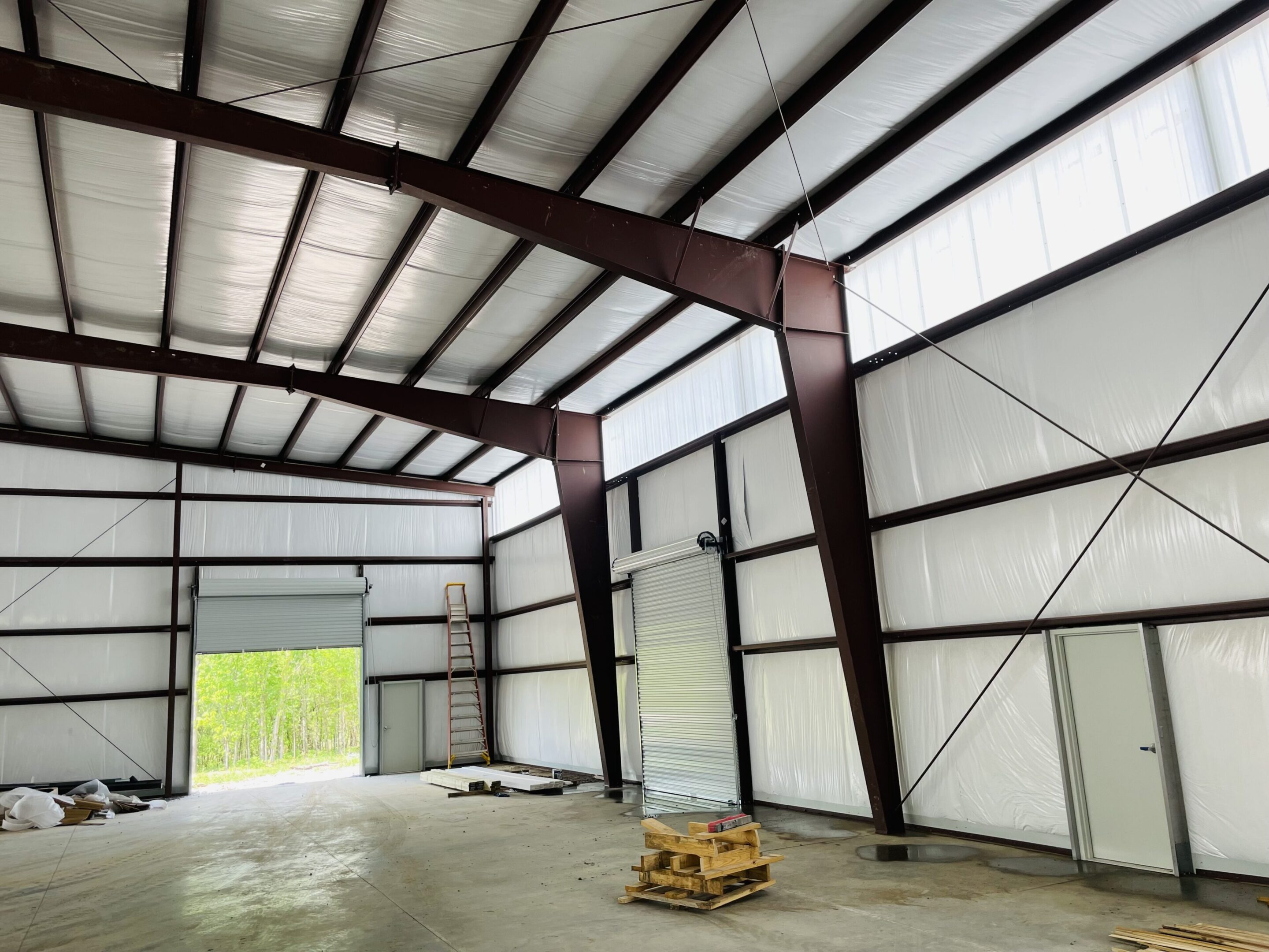 A warehouse with a large metal structure in the middle of it.