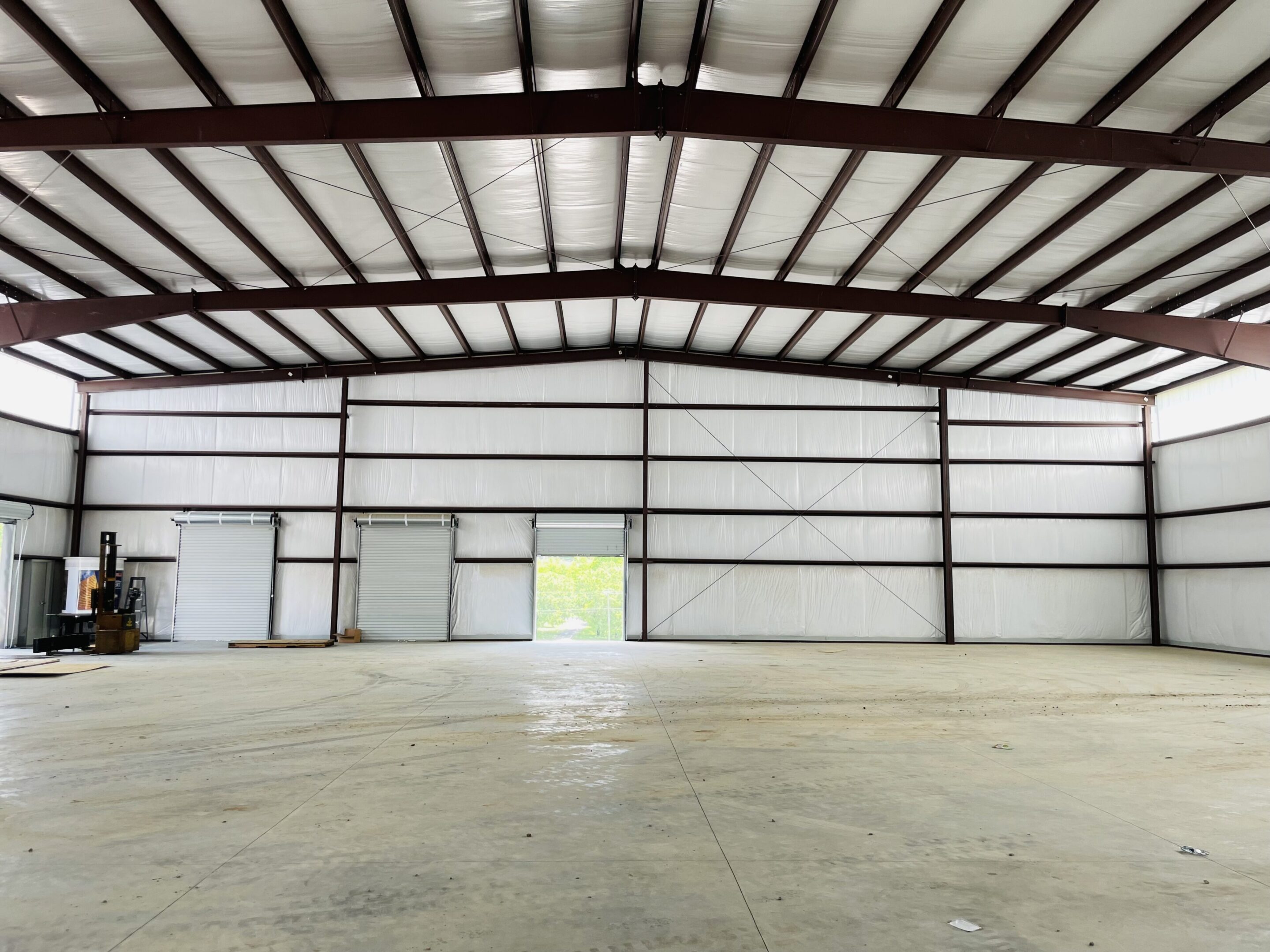 A large warehouse with lots of windows and doors.